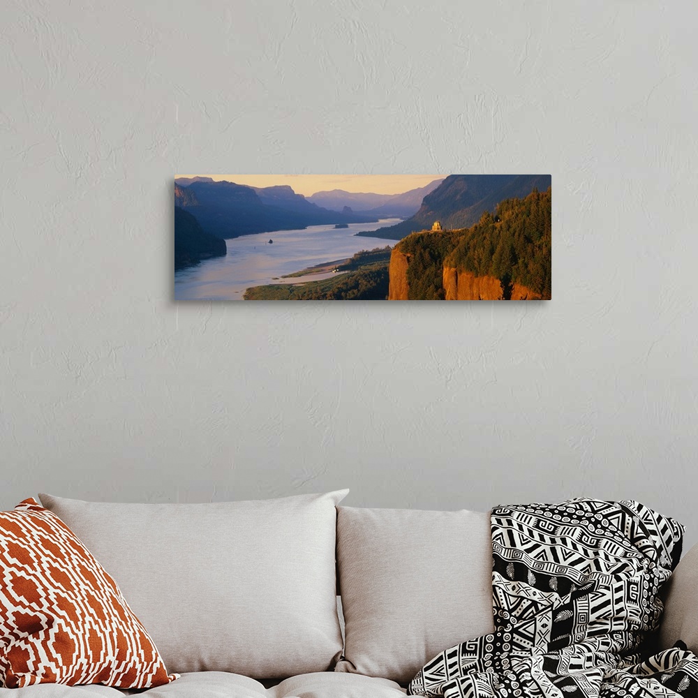 A bohemian room featuring Panoramic canvas photo of a wide river flowing through rolling mountains and cliffs.