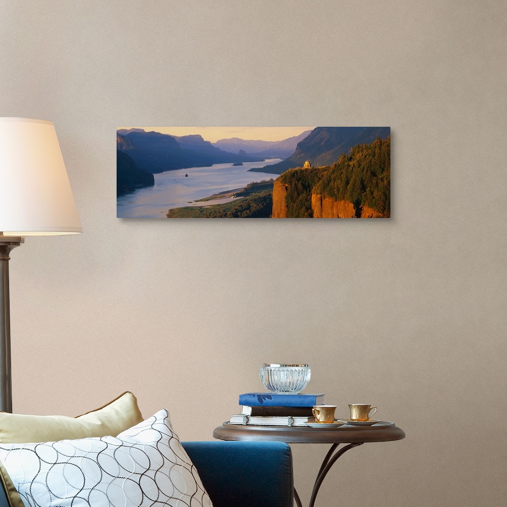 A traditional room featuring Panoramic canvas photo of a wide river flowing through rolling mountains and cliffs.