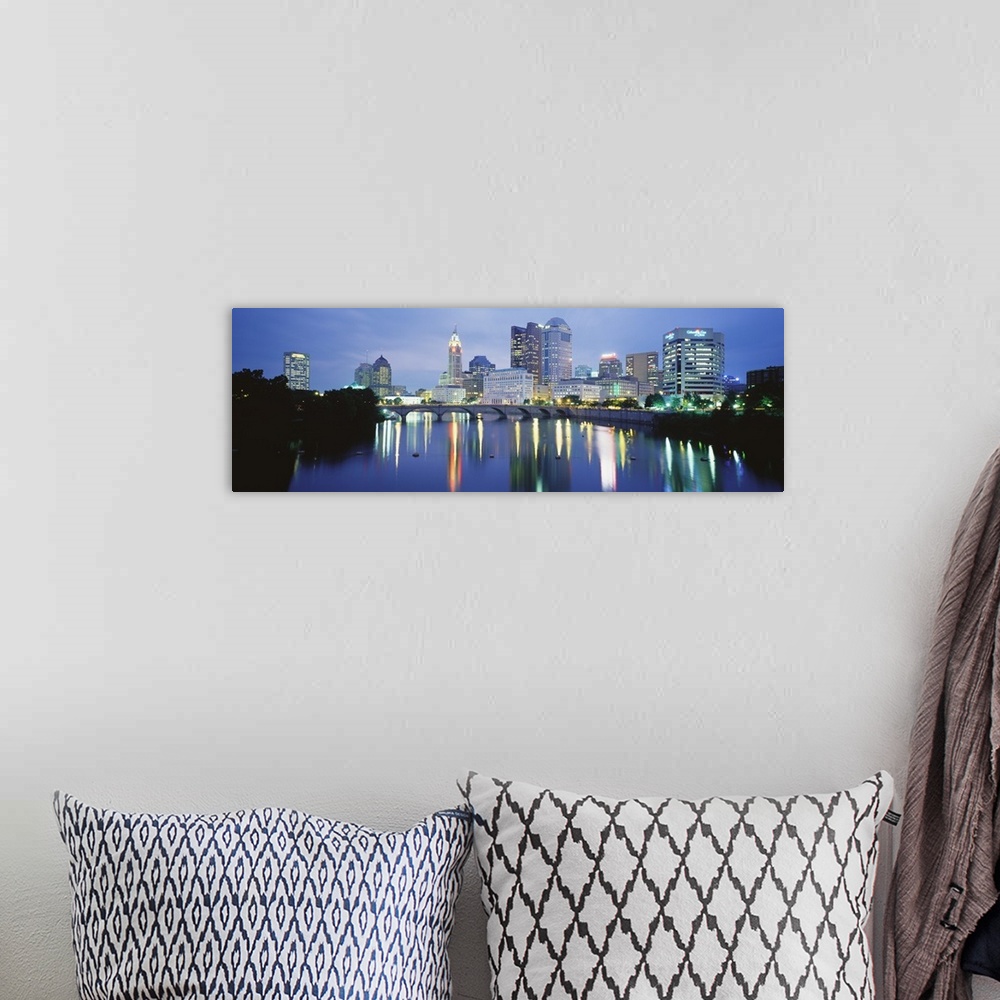 A bohemian room featuring Giant, horizontal photograph of the Columbus skyline at night, reflecting in the waters of the Sc...