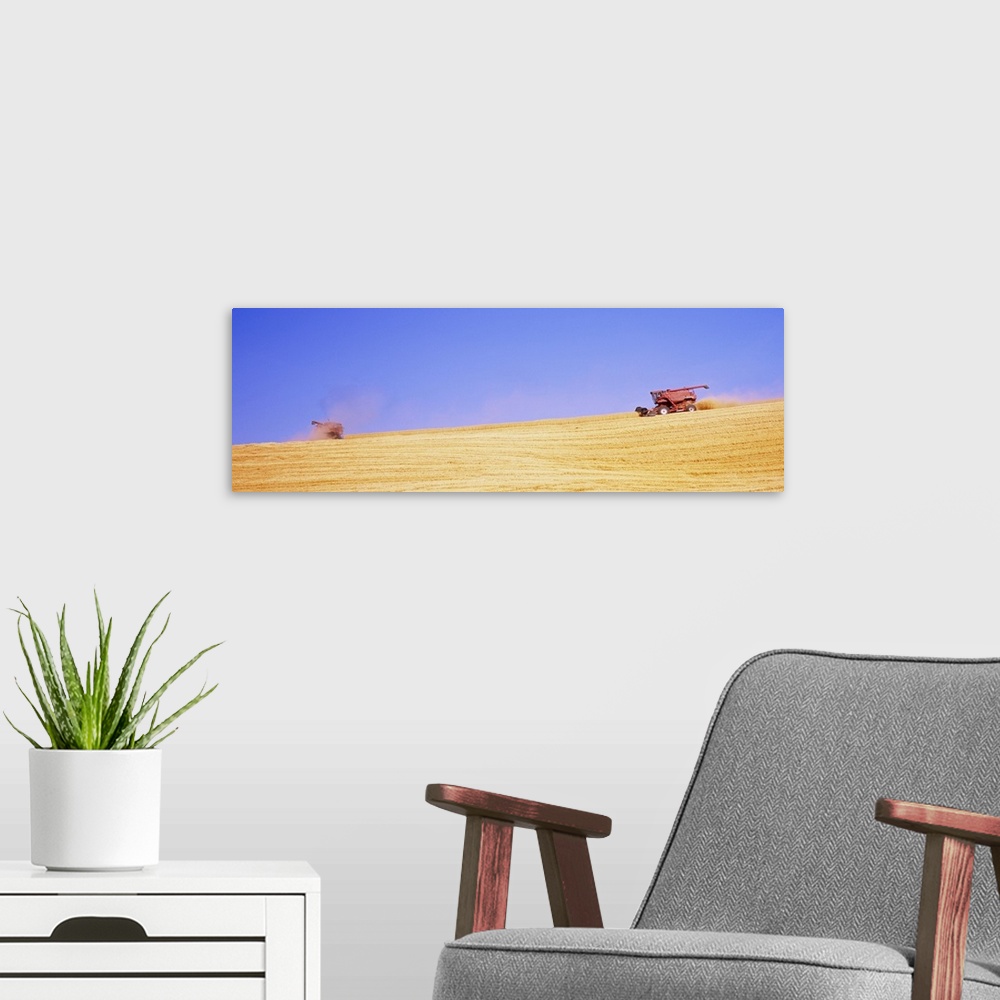 A modern room featuring Combine harvesters harvesting wheat crop in a field, Washington State