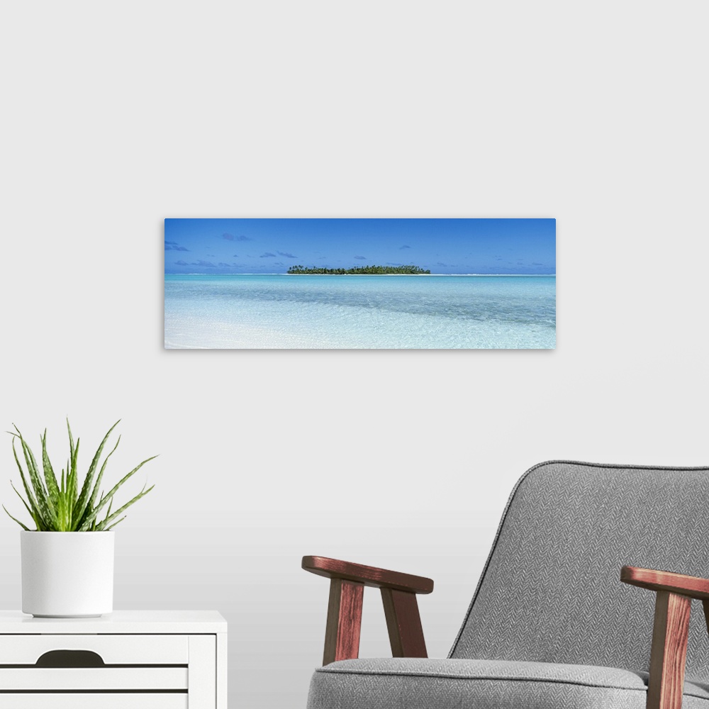 A modern room featuring Panoramic photograph on a big canvas of the clear blue waters of the South Pacific, the Cook Isla...
