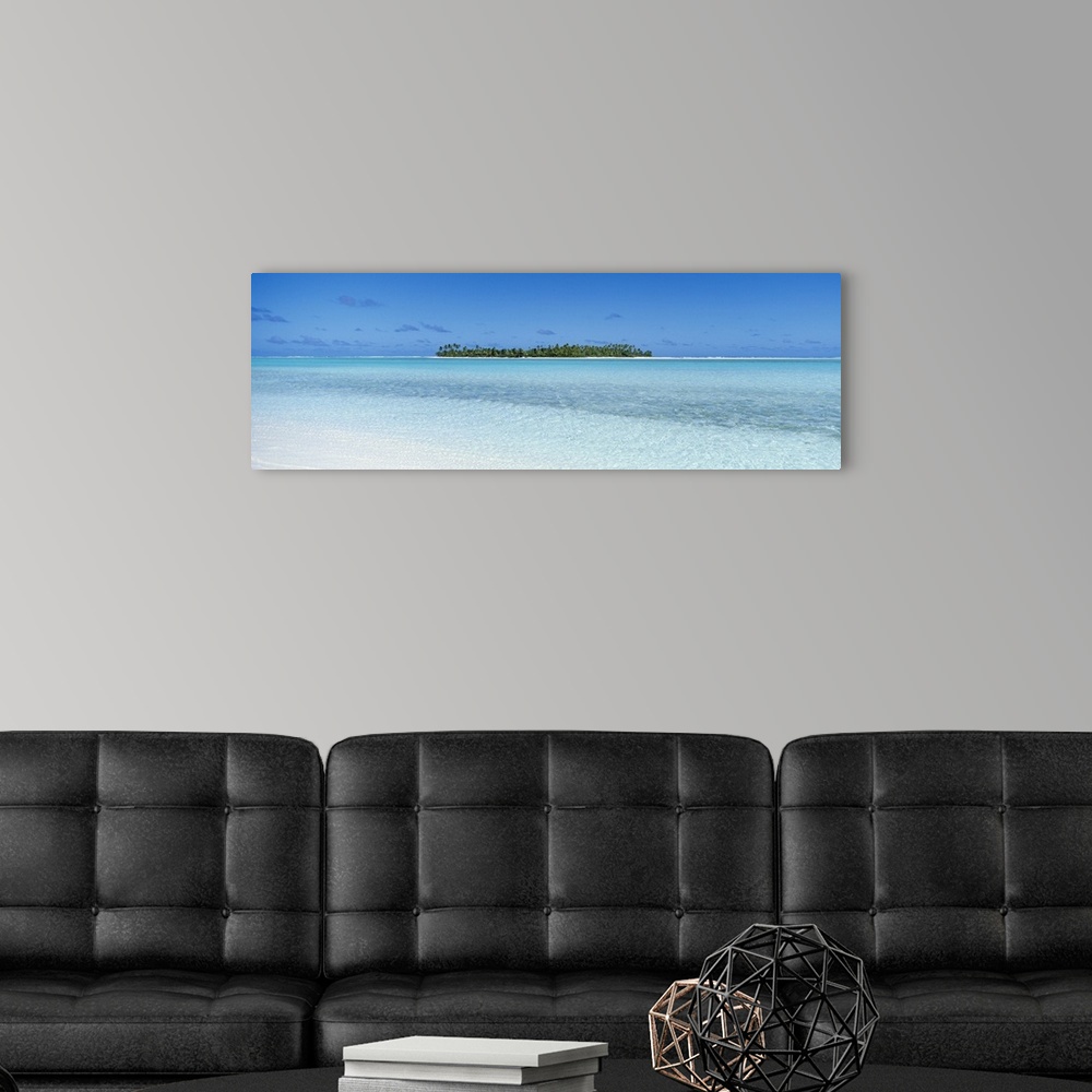 A modern room featuring Panoramic photograph on a big canvas of the clear blue waters of the South Pacific, the Cook Isla...