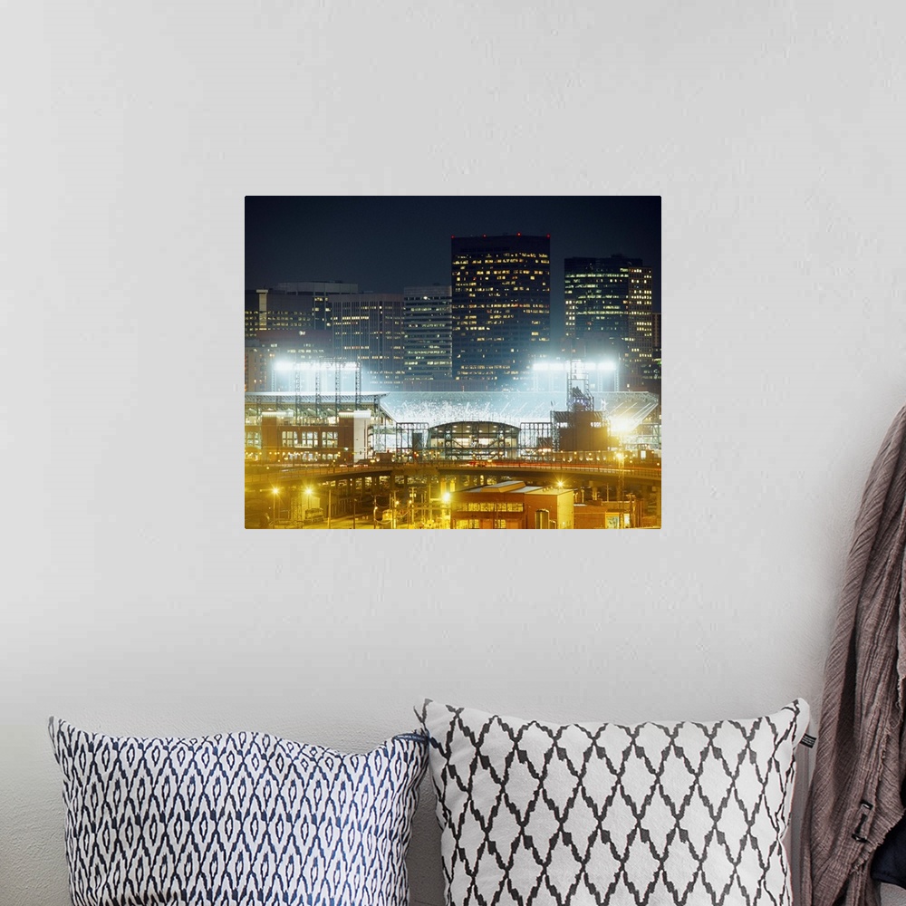 A bohemian room featuring Photograph of baseball stadium that is the home of the MLB team the Colorado Rockies.  There are ...