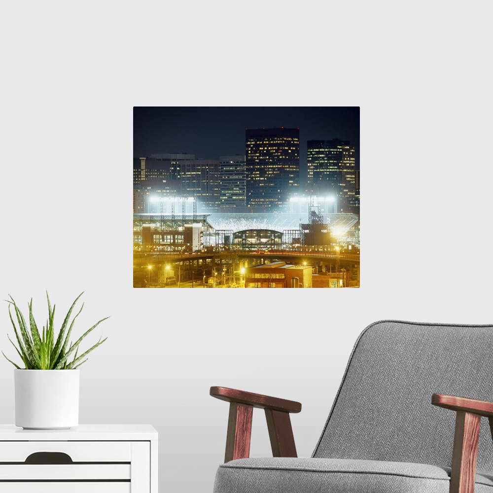 A modern room featuring Photograph of baseball stadium that is the home of the MLB team the Colorado Rockies.  There are ...