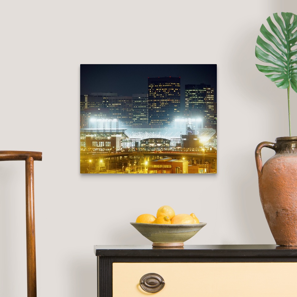 A traditional room featuring Photograph of baseball stadium that is the home of the MLB team the Colorado Rockies.  There are ...