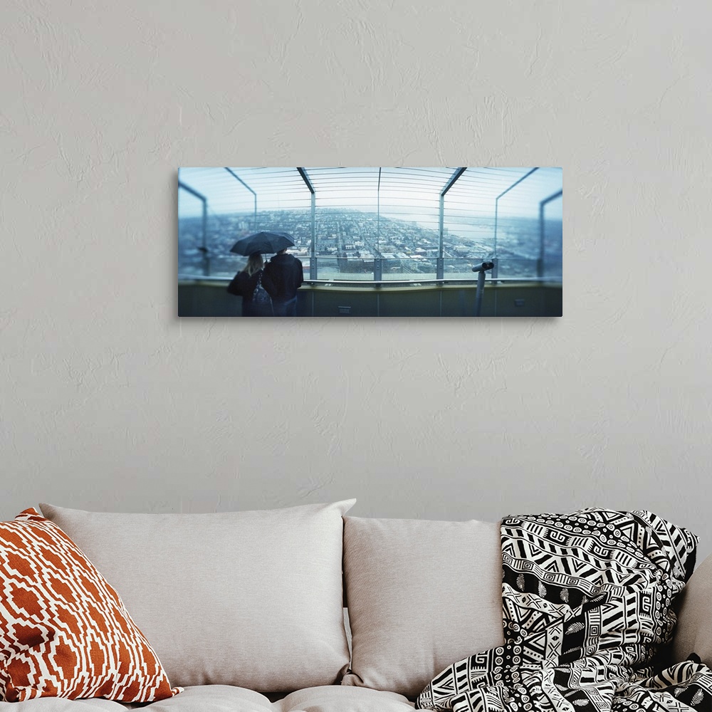 A bohemian room featuring Couple viewing a city from the Space Needle Queen Anne Hill Seattle Washington State