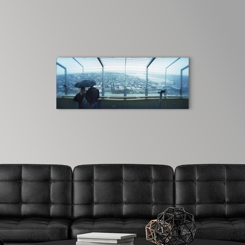 A modern room featuring Couple viewing a city from the Space Needle Queen Anne Hill Seattle Washington State