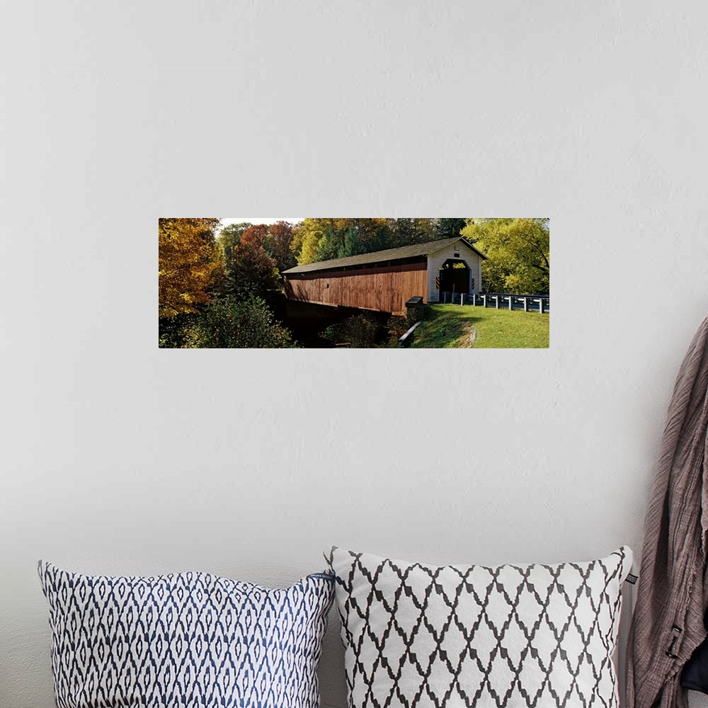 A bohemian room featuring Panoramic photograph of the wooden McGees Mill covered bridge, surrounded by a forest of trees wi...