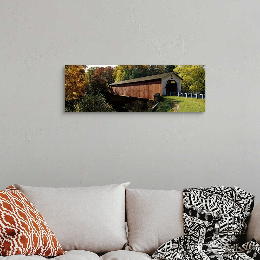 A bohemian room featuring Panoramic photograph of the wooden McGees Mill covered bridge, surrounded by a forest of trees wi...