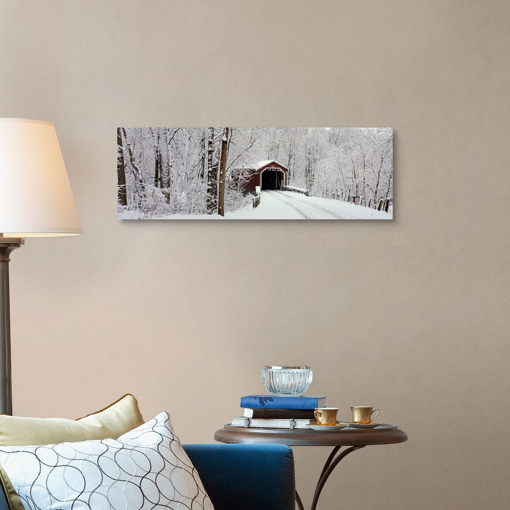A traditional room featuring Panoramic photograph of a snow covered bridge in Pennsylvania that is surrounded by a forest.
