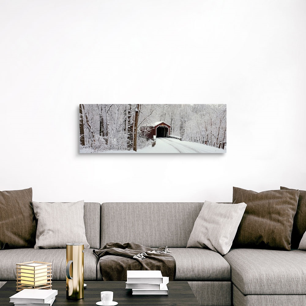 A traditional room featuring Panoramic photograph of a snow covered bridge in Pennsylvania that is surrounded by a forest.