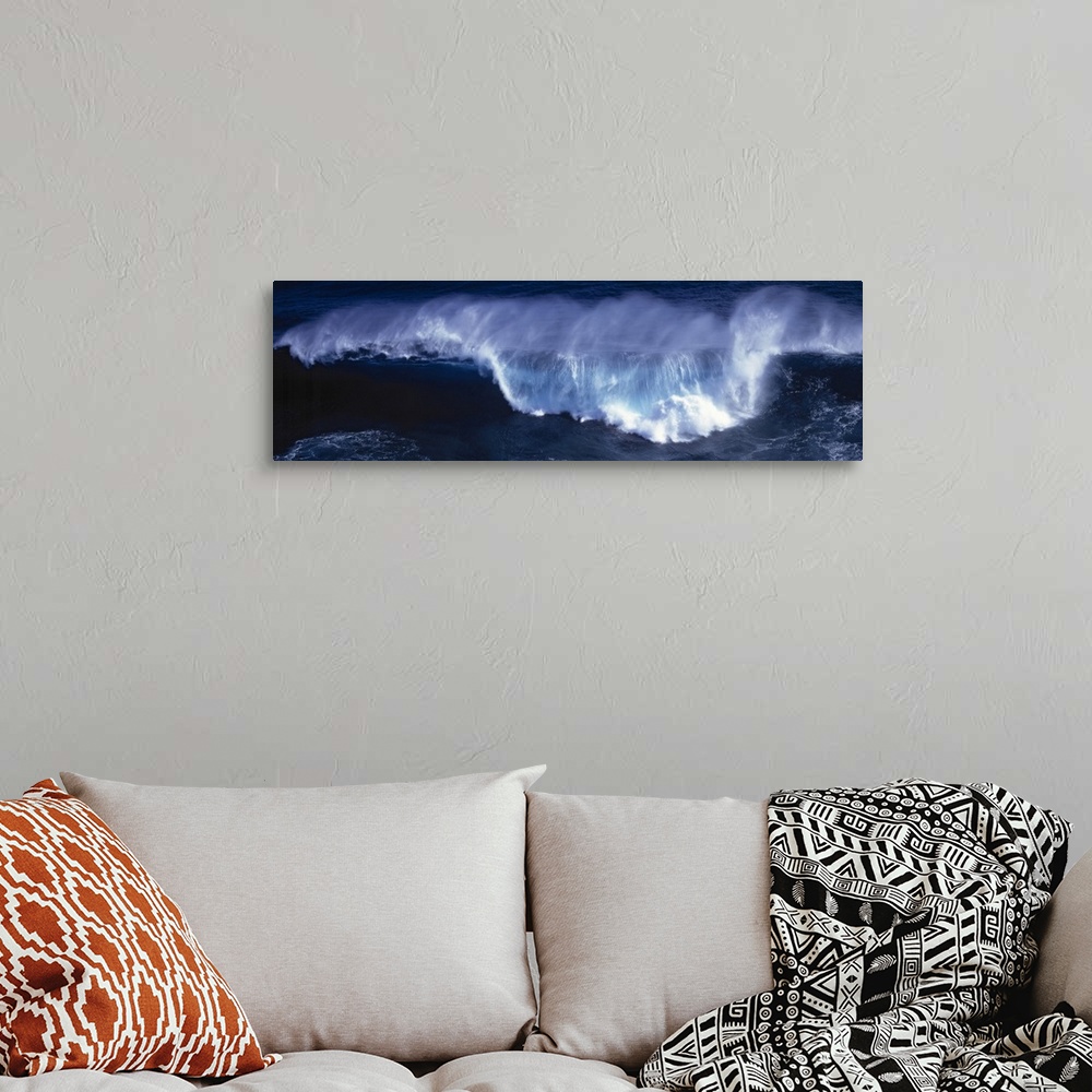 A bohemian room featuring Wide angle shot of a huge wave that has begun to crash down.