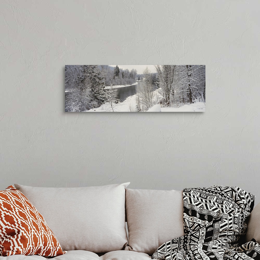 A bohemian room featuring River and surrounding trees blanketed in snow from a recent snowfall, giving the landscape a quie...