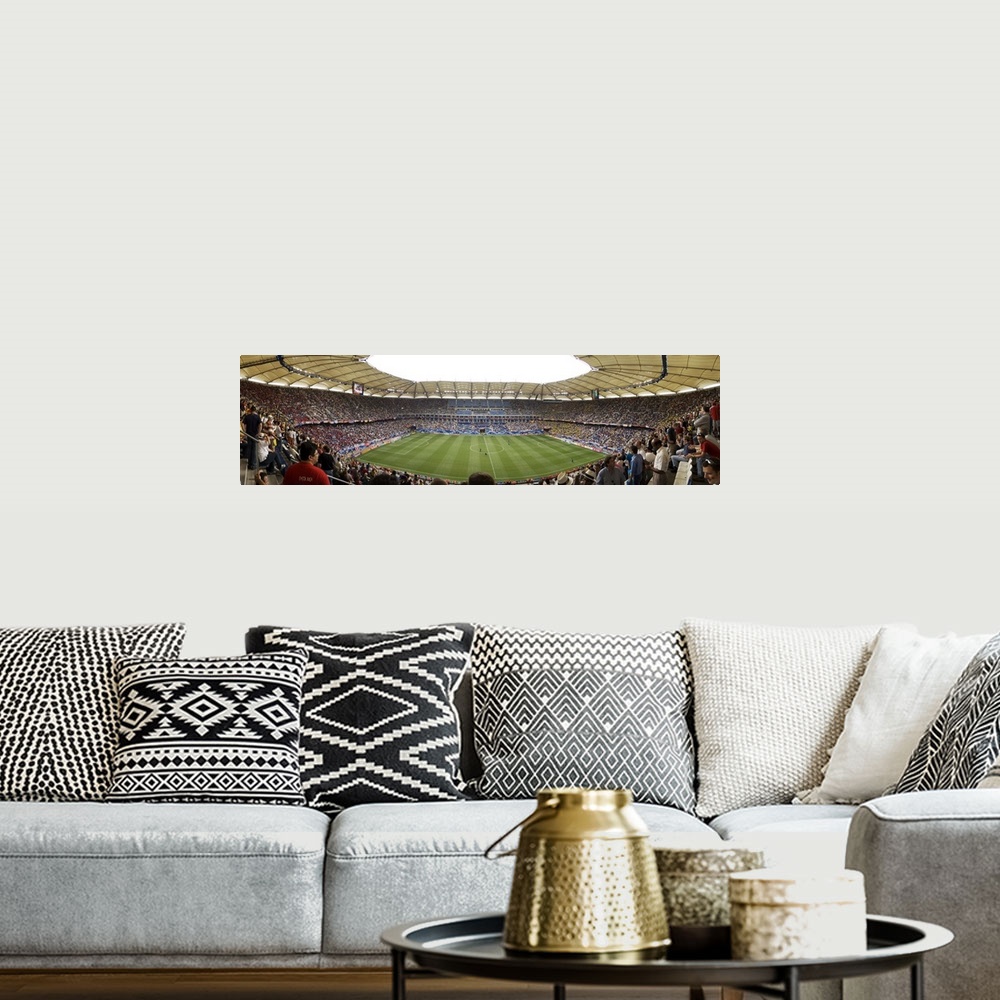 A bohemian room featuring Wide angle photograph of large stadium full of fans, watching a soccer game in Hamburg, Germany.