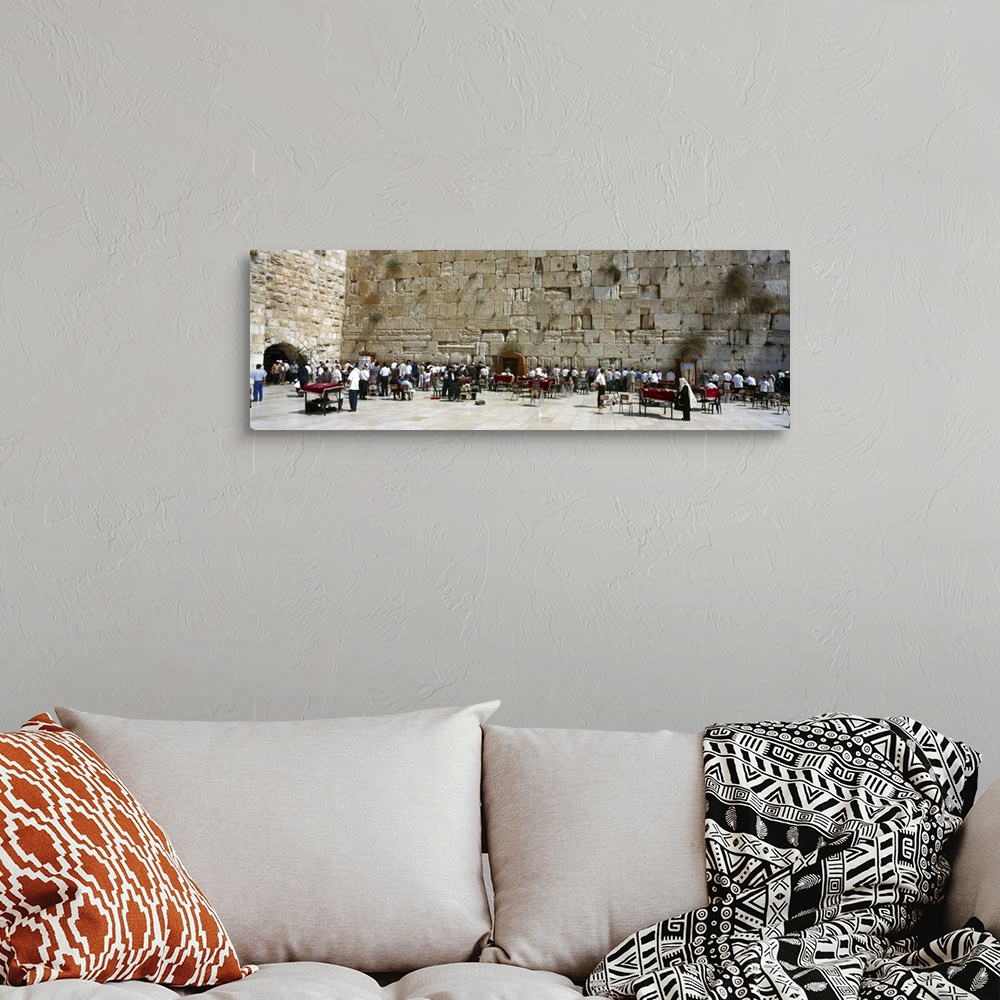 A bohemian room featuring Crowd praying in front of a stone wall Wailing Wall Jerusalem Israel