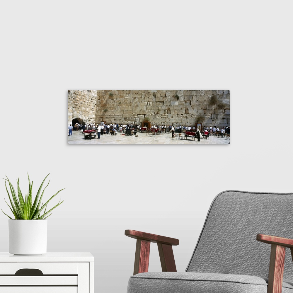 A modern room featuring Crowd praying in front of a stone wall Wailing Wall Jerusalem Israel