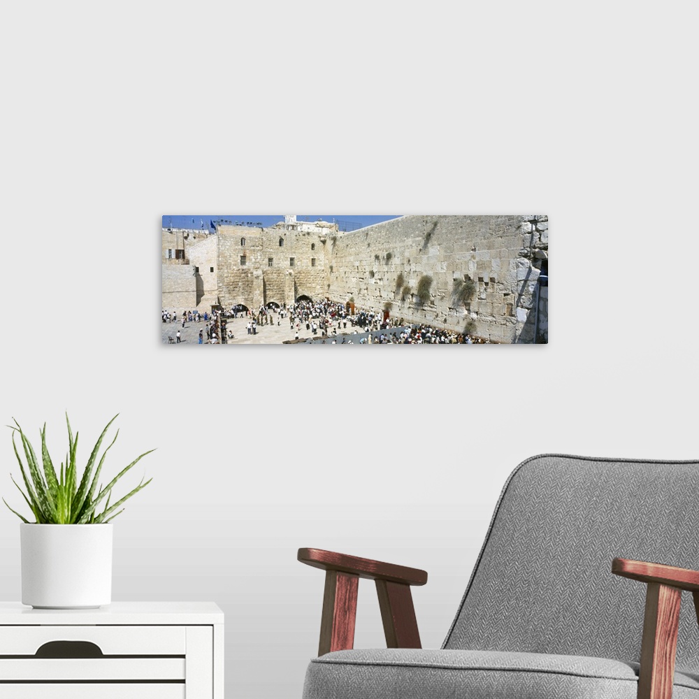 A modern room featuring Crowd praying in front of a stone wall Wailing Wall Jerusalem Israel