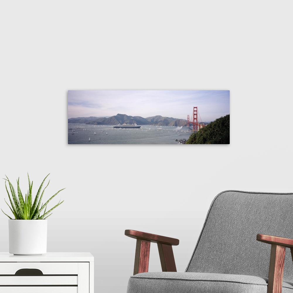 A modern room featuring Cruise ship approaching a suspension bridge, RMS Queen Mary 2, Golden Gate Bridge, San Francisco,...