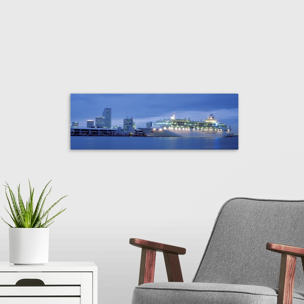 A modern room featuring Panoramic of Miami Port featuring a cruiseship and downtown buildings.