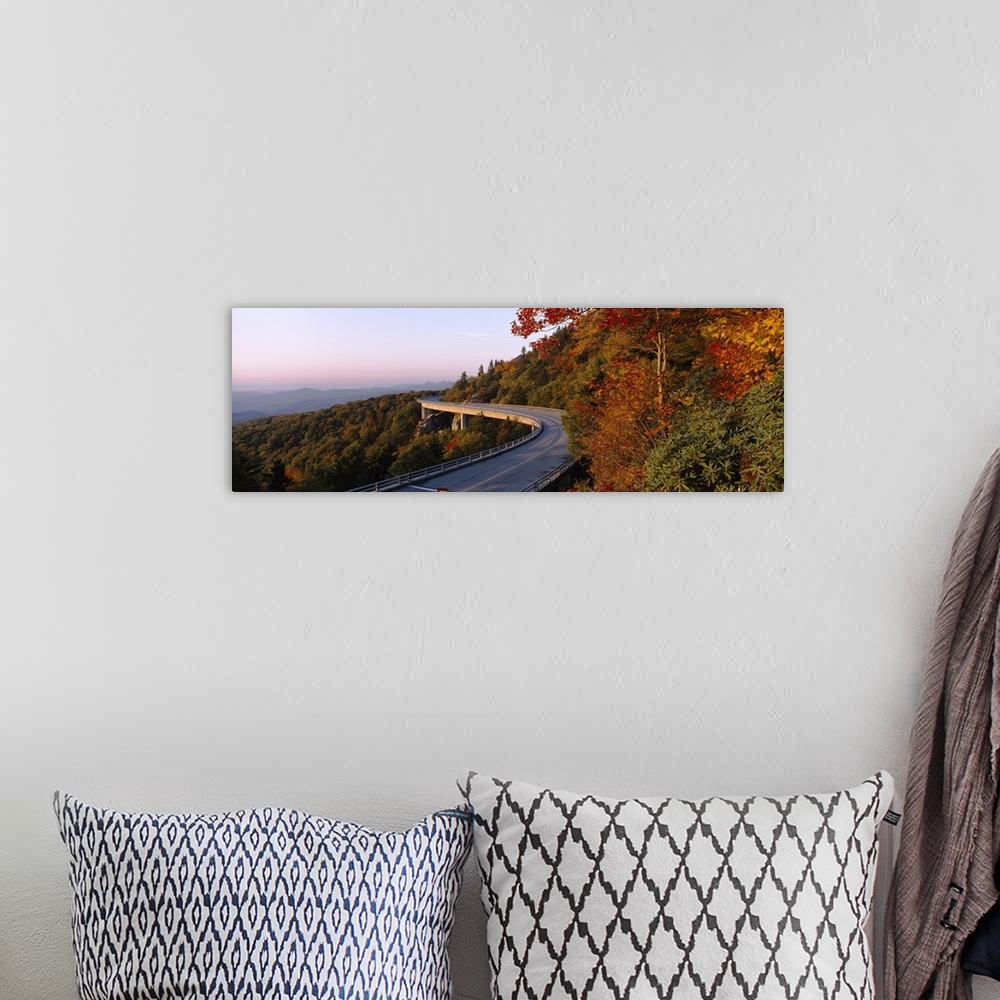 A bohemian room featuring Panoramic photograph of winding mountain road with tree tops below it and mountain silhouette in ...