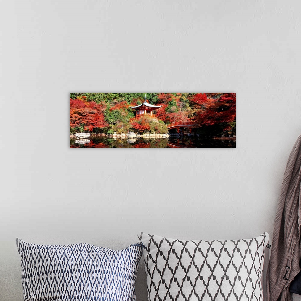 A bohemian room featuring Panoramic photograph of ancient Asian sanctuary on waterway surrounded by forest.