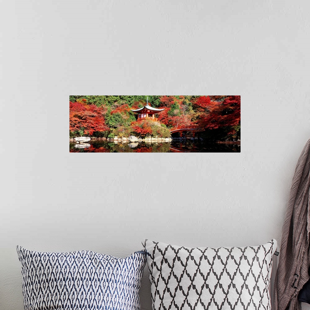 A bohemian room featuring Panoramic photograph of ancient Asian sanctuary on waterway surrounded by forest.
