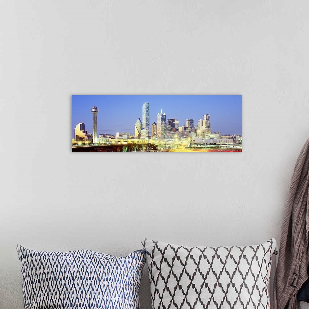 A bohemian room featuring Giant, landscape photograph of a highway road leading toward the lit up Dallas skyline against a ...