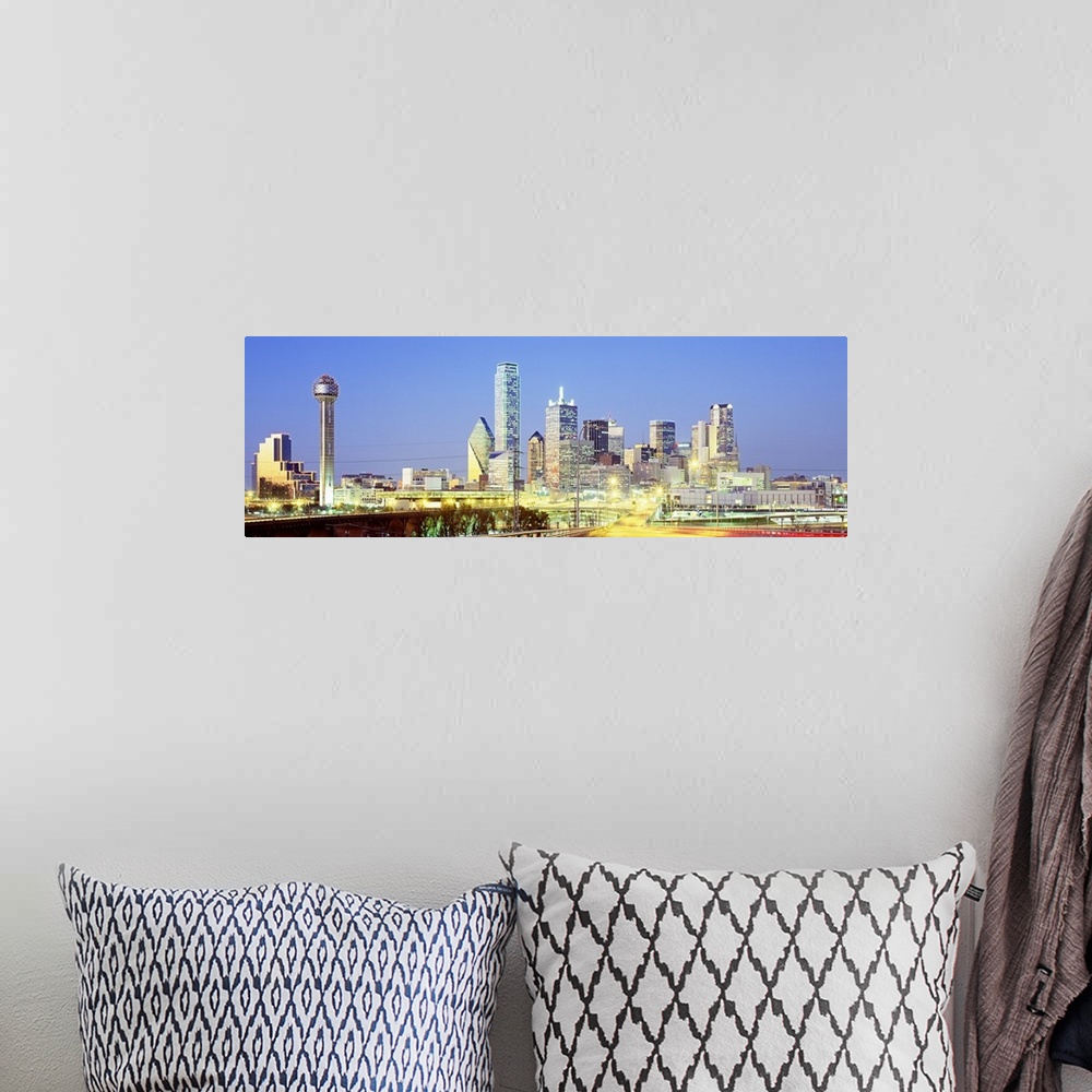 A bohemian room featuring Giant, landscape photograph of a highway road leading toward the lit up Dallas skyline against a ...