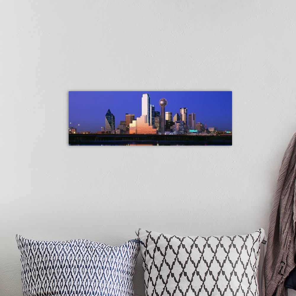 A bohemian room featuring A large panoramic piece that is a photograph of the Dallas skyline at dusk.