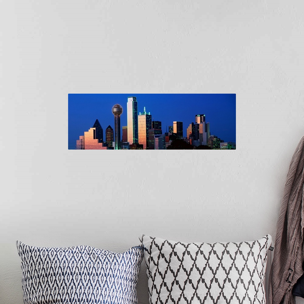 A bohemian room featuring This panoramic photograph shows the city skyscrapers in the evening light.