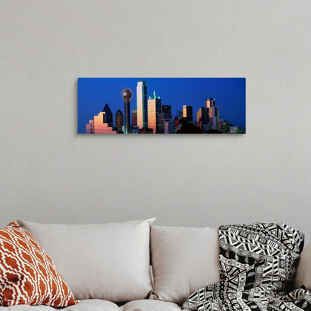 A bohemian room featuring This panoramic photograph shows the city skyscrapers in the evening light.