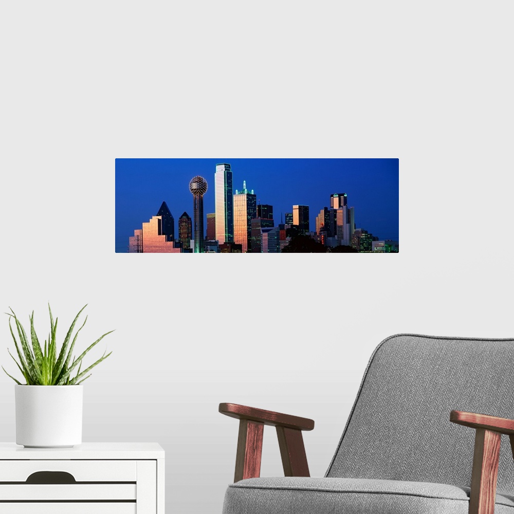 A modern room featuring This panoramic photograph shows the city skyscrapers in the evening light.