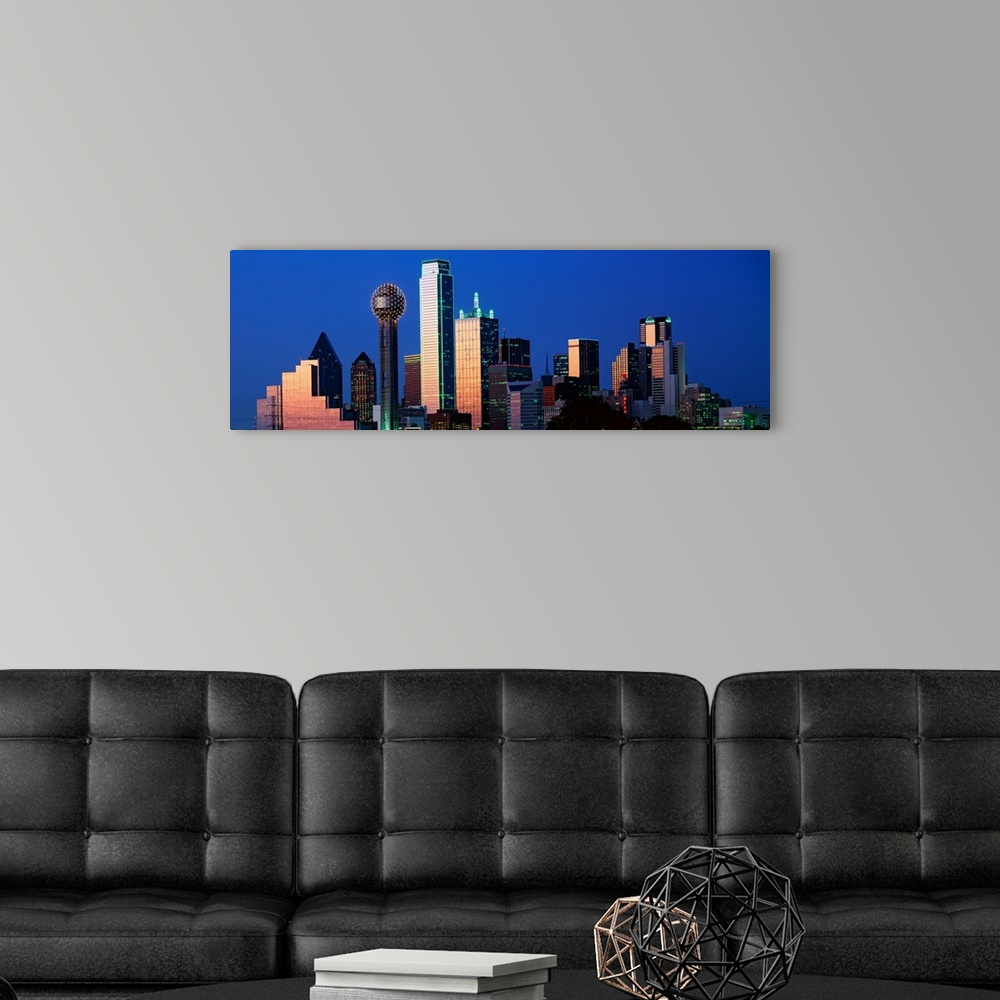 A modern room featuring This panoramic photograph shows the city skyscrapers in the evening light.