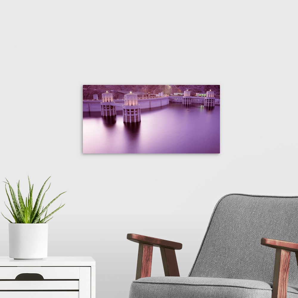 A modern room featuring Horizontal photograph of the still surface of an impounded lake at twilight next to a concrete ar...
