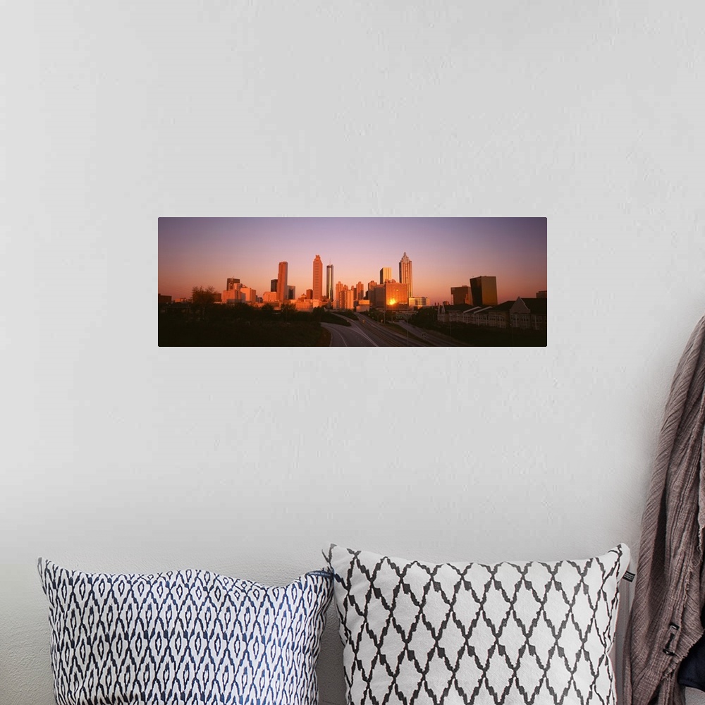 A bohemian room featuring Giant, horizontal photograph of the sun rising over the Atlanta skyline, several roads and a row ...