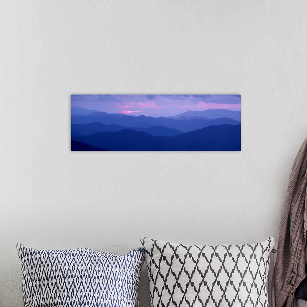 A bohemian room featuring A panoramic photograph of the Appalachian Mountains under a pastel colored sky at sunrise.