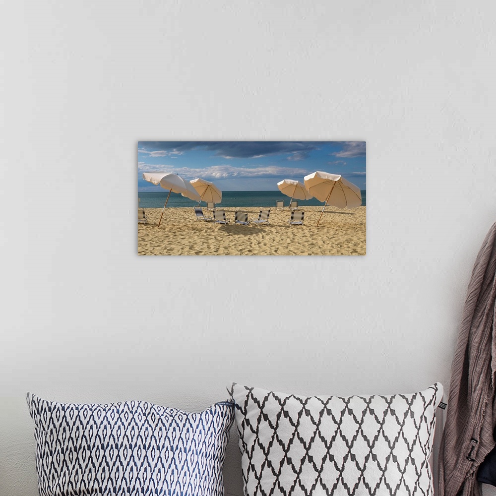 A bohemian room featuring Landscape photograph of a heavily traveled beach on the New England coast with clouds gathering i...
