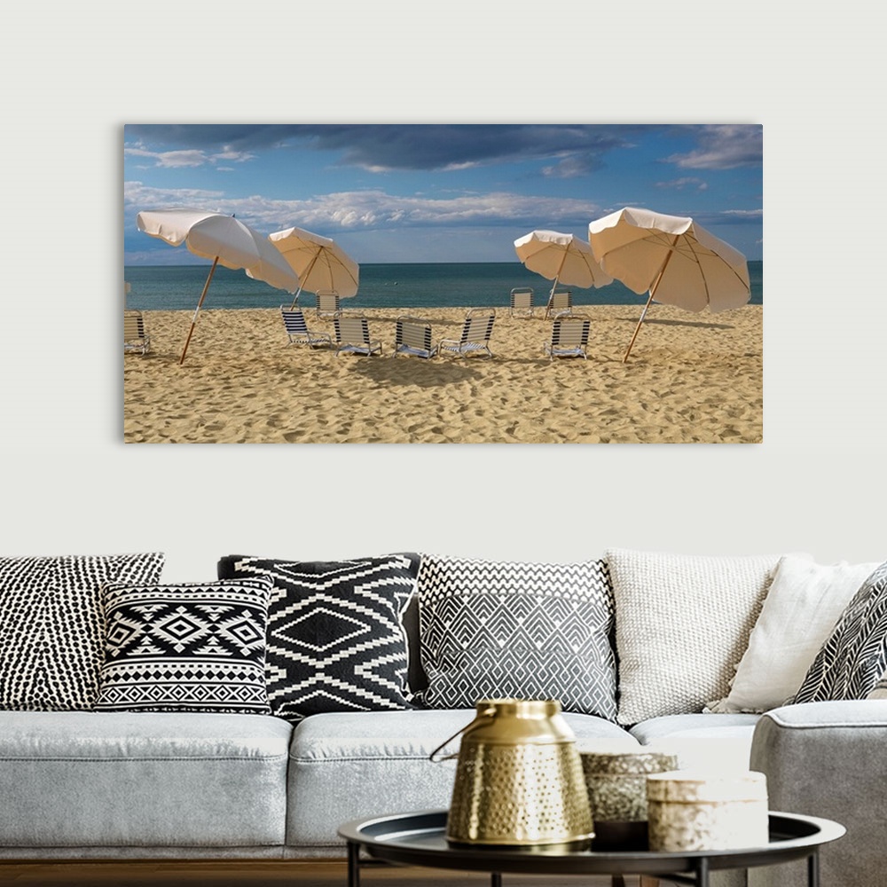 A bohemian room featuring Landscape photograph of a heavily traveled beach on the New England coast with clouds gathering i...