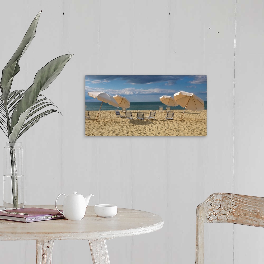 A farmhouse room featuring Landscape photograph of a heavily traveled beach on the New England coast with clouds gathering i...