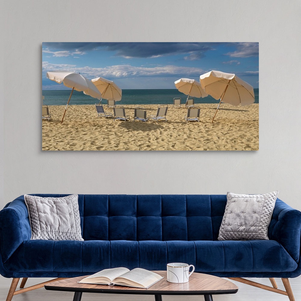 A modern room featuring Landscape photograph of a heavily traveled beach on the New England coast with clouds gathering i...