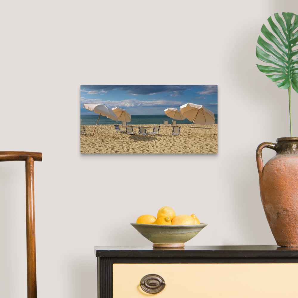 A traditional room featuring Landscape photograph of a heavily traveled beach on the New England coast with clouds gathering i...