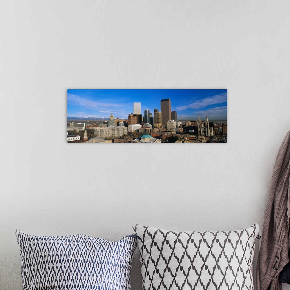 A bohemian room featuring Panoramic photo of a downtown cityscape in Colorado against a bright blue sky.