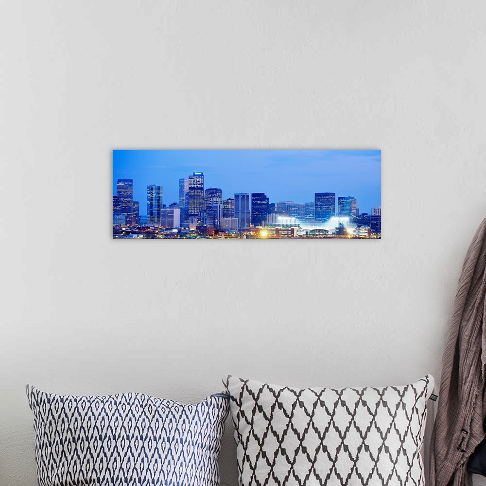 A bohemian room featuring A panoramic skyline photograph showing city lit up at night.
