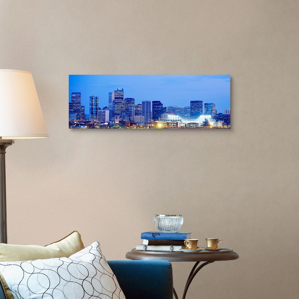 A traditional room featuring A panoramic skyline photograph showing city lit up at night.