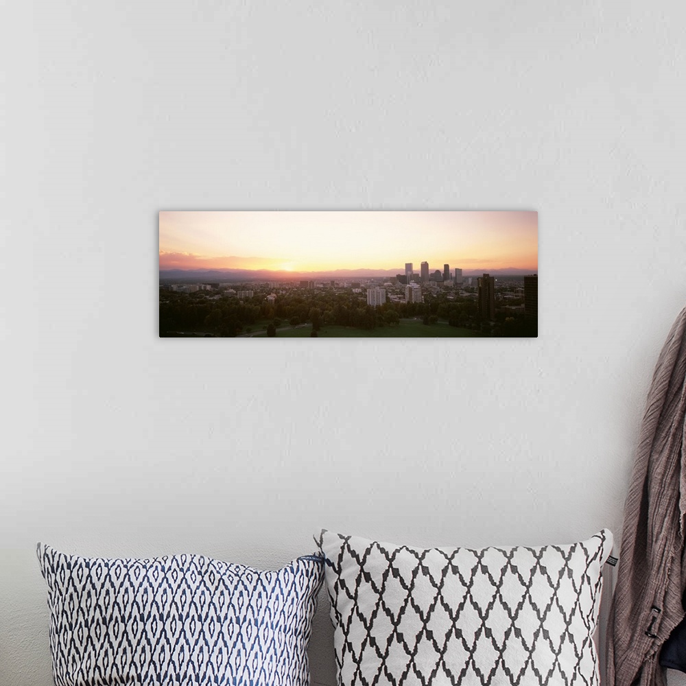 A bohemian room featuring Panoramic photograph of the sunrise above the Denver, Colorado skyline and park.