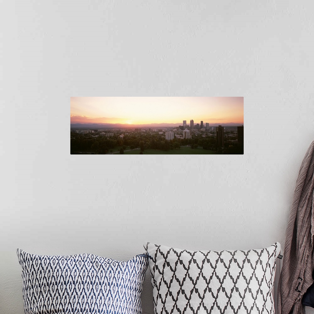 A bohemian room featuring Panoramic photograph of the sunrise above the Denver, Colorado skyline and park.