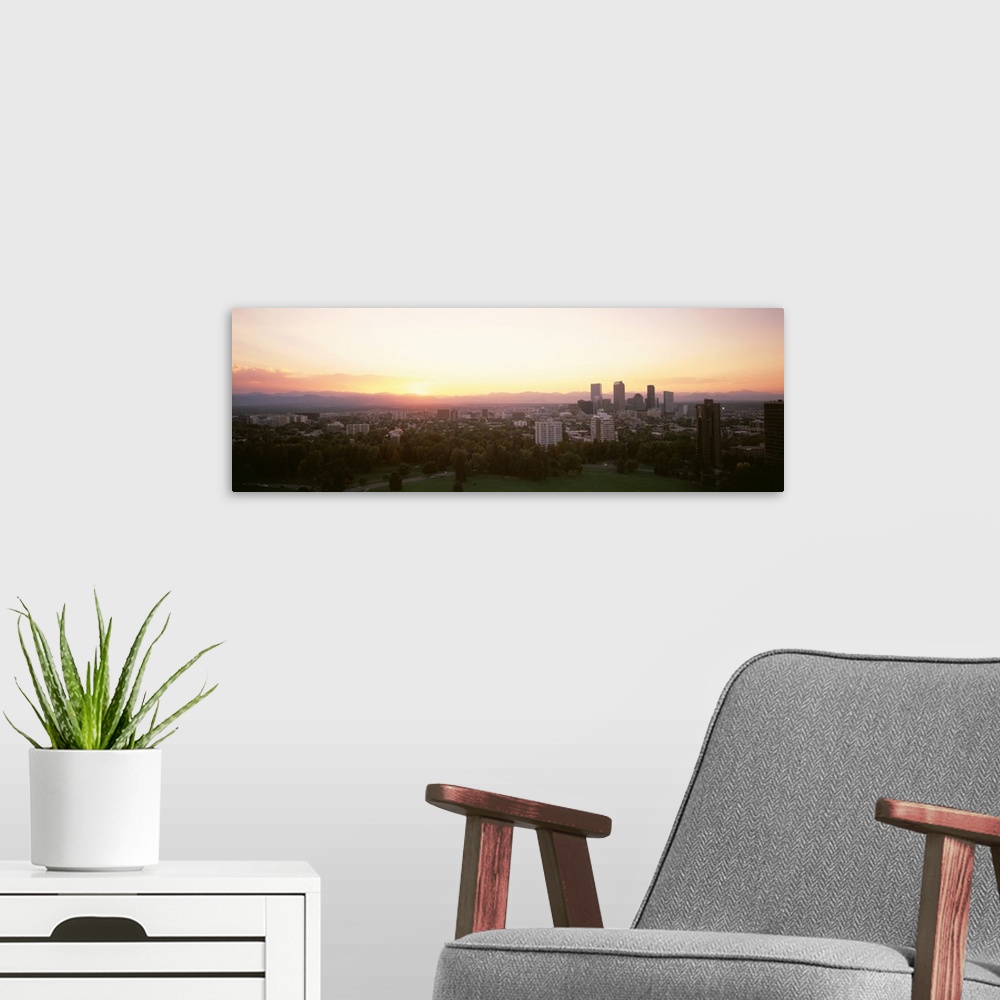 A modern room featuring Panoramic photograph of the sunrise above the Denver, Colorado skyline and park.