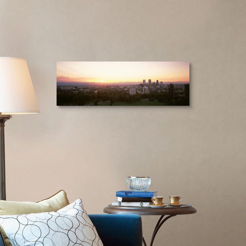 A traditional room featuring Panoramic photograph of the sunrise above the Denver, Colorado skyline and park.