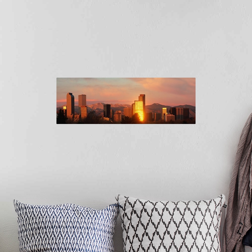 A bohemian room featuring A panoramic shot taken of the Denver skyline while the sun is setting and reflecting off some of ...