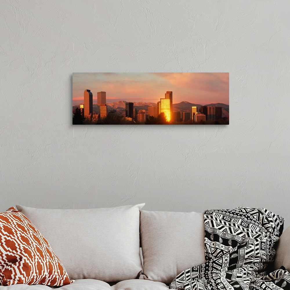 A bohemian room featuring A panoramic shot taken of the Denver skyline while the sun is setting and reflecting off some of ...
